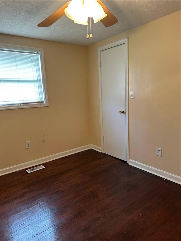 615 Cassville Road Southeast, Unit A Cartersville, GA 30120 - Photo 13 of 21 an empty room with wooden floor and windows