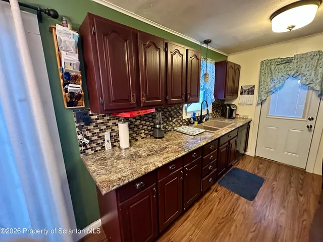 a bedroom with a bed and a flat tv screen on dresser