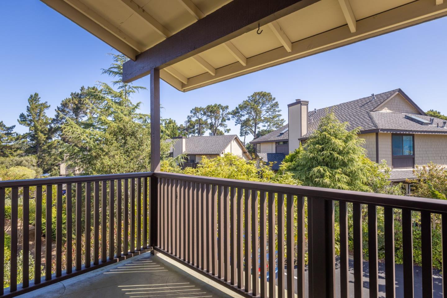 1360 Josselyn Canyon Road, Unit 40 Monterey, CA 93940 - Photo 13 of 18 a view of a balcony with wooden floor and fence