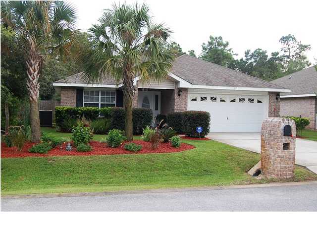 105 Bayou Landing Road Miramar Beach, FL 32550 - Photo 1 of 15 a front view of a house with a garden and plants