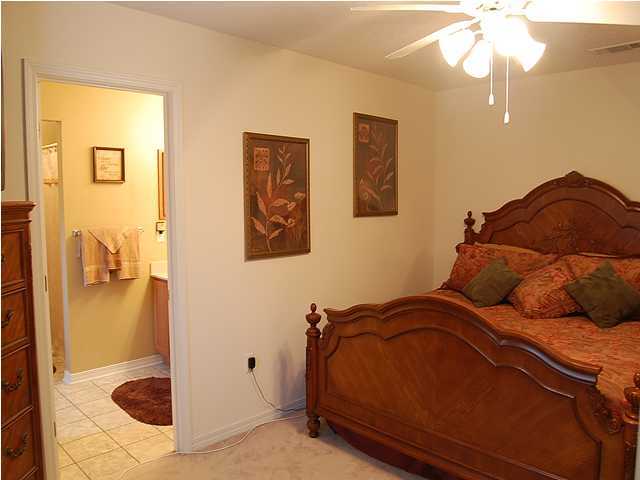 105 Bayou Landing Road Miramar Beach, FL 32550 - Photo 9 of 15 a bedroom with a bed and a chandelier