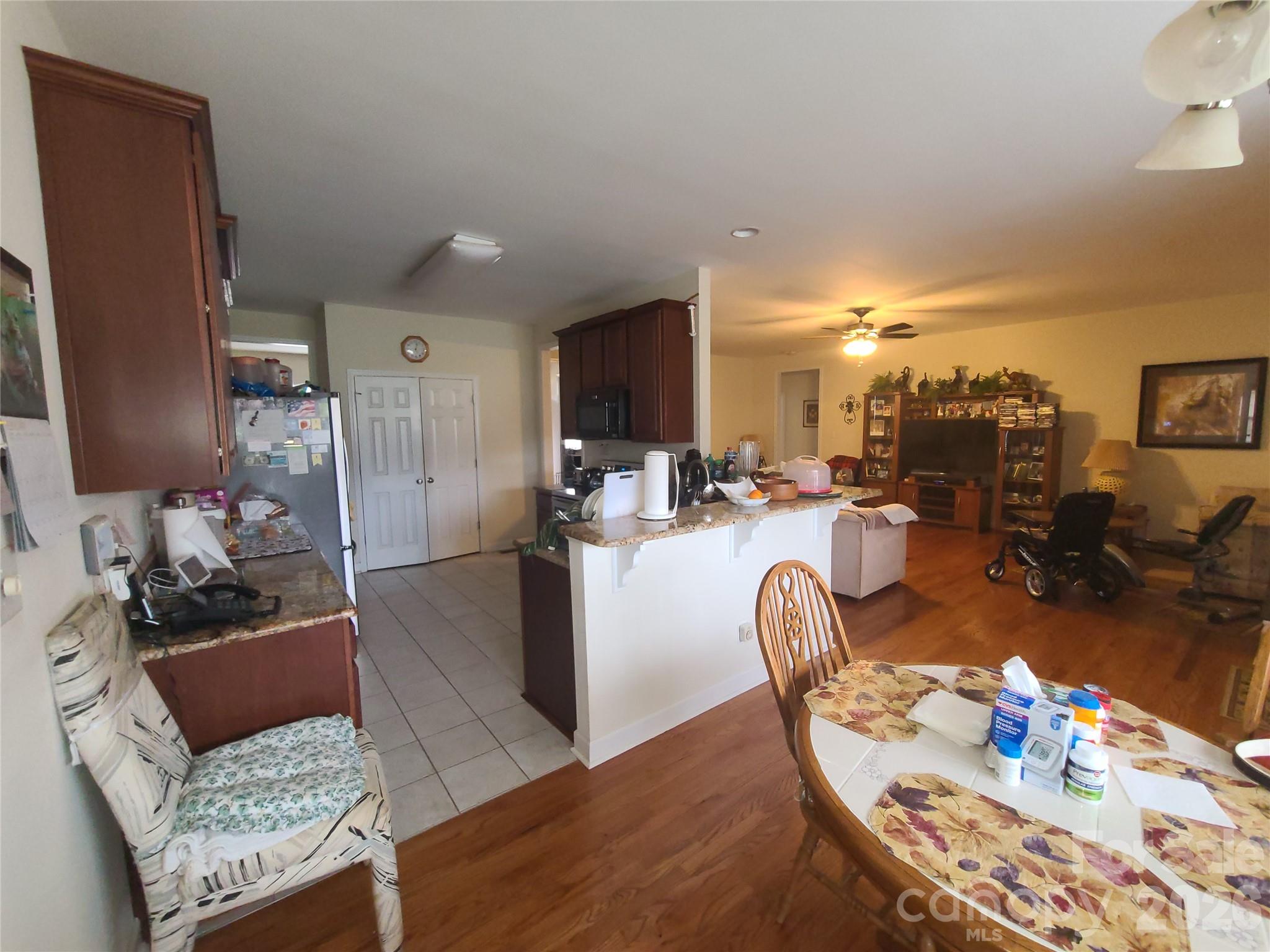 1638 Bess Town Road Bessemer City, NC 28016 - Photo 16 of 31 a living room with furniture a chandelier and a dining table with kitchen view