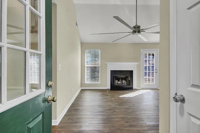 a view of an empty room with a fireplace and a window