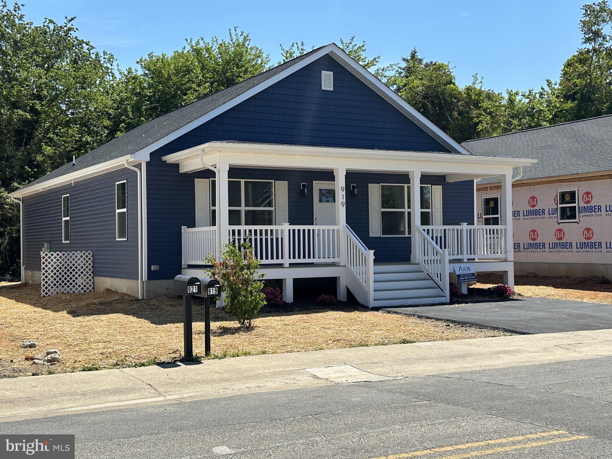 a front view of a house with a yard outdoor seating and garage