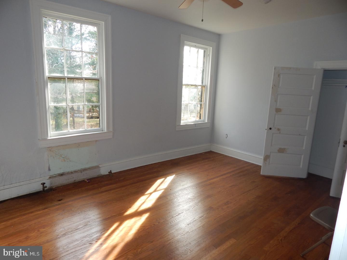 605 Upland Road Pikesville, MD 21208 - Photo 12 of 38 an empty room with wooden floor and windows
