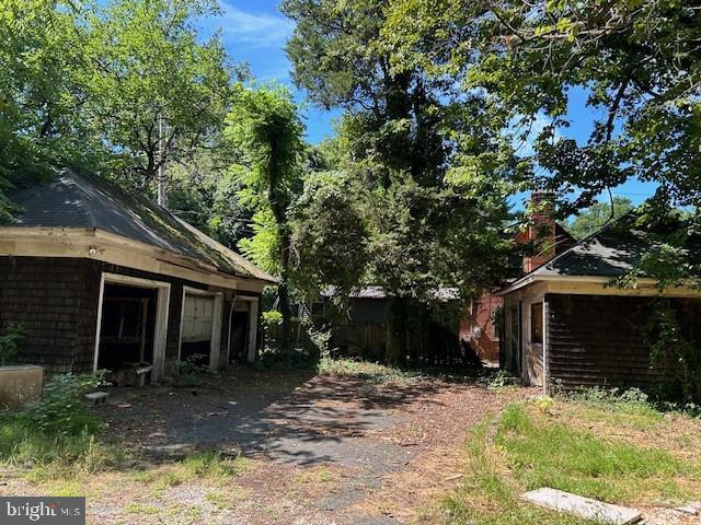 605 Upland Road Pikesville, MD 21208 - Photo 16 of 38 a front view of a house with a yard and garage