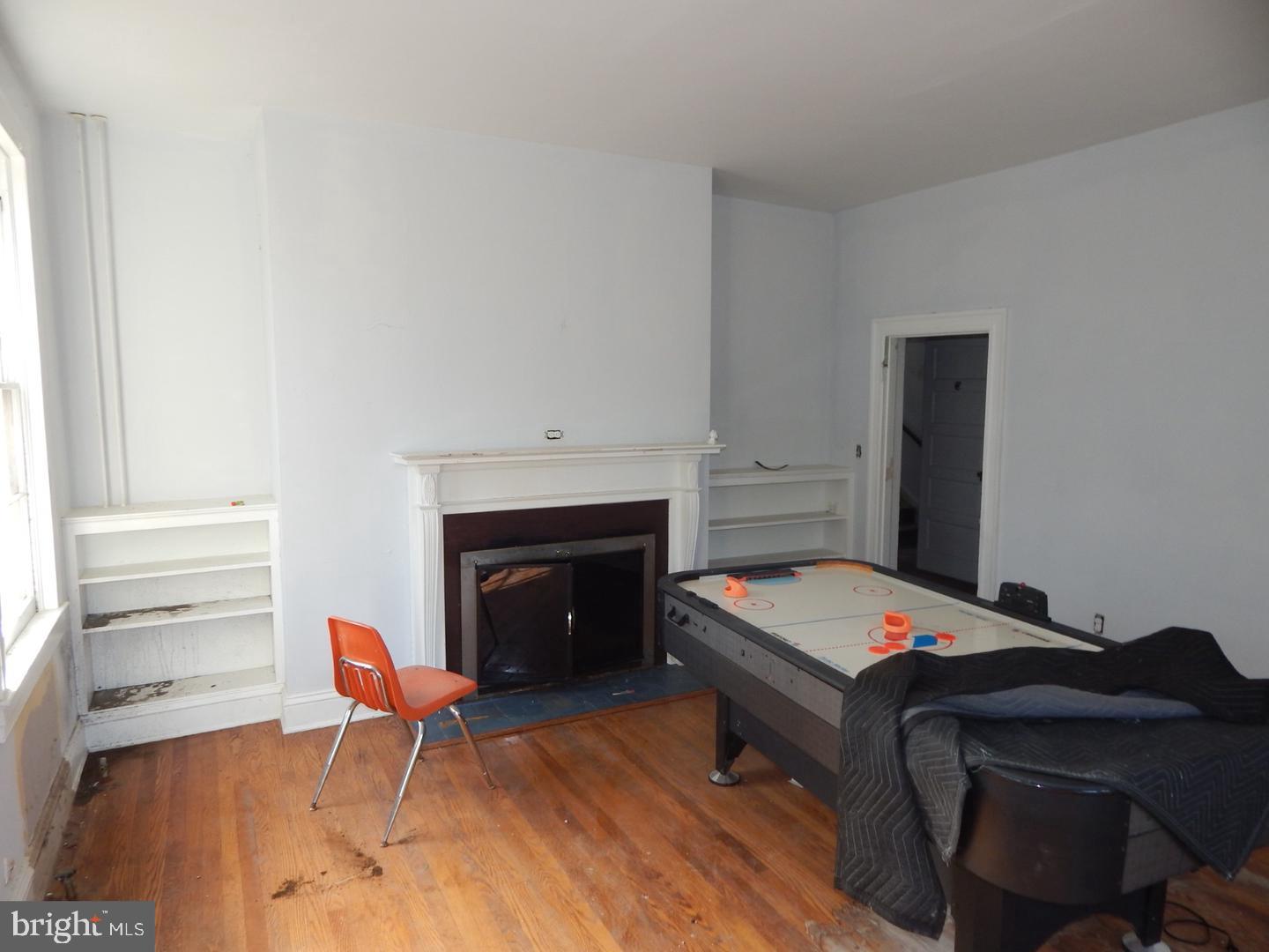 605 Upland Road Pikesville, MD 21208 - Photo 6 of 38 a bedroom with a bed and a fireplace