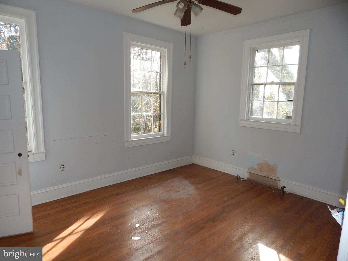 605 Upland Road Pikesville, MD 21208 - Photo 10 of 38 wooden floor in an empty room with a window