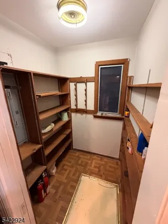a view of living room with furniture and a refrigerator