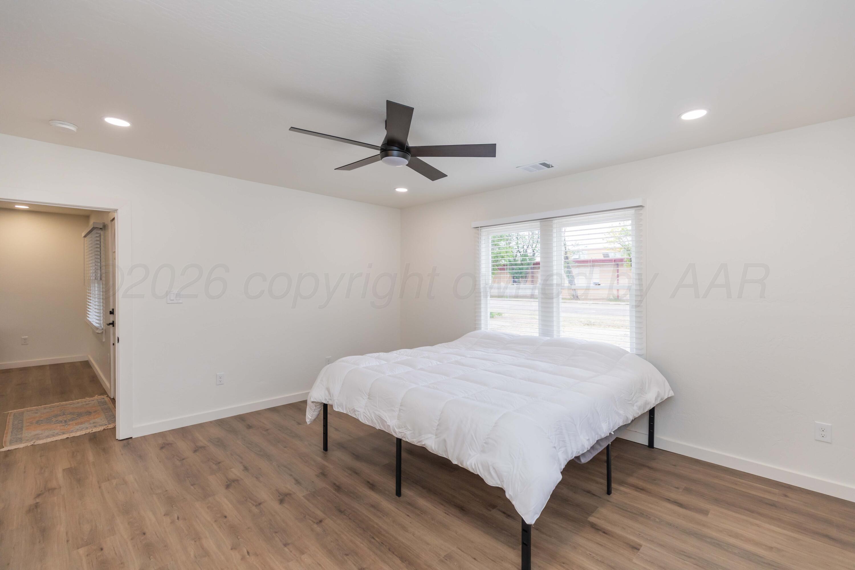 504 High Street Claude, TX 79019 - Photo 32 of 39 a workspace with wooden floor and a window