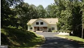 a view of a white house with a yard