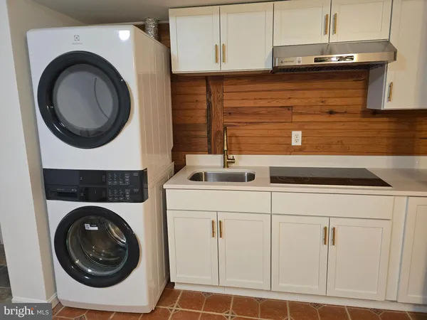 a utility room with sink dryer and washer