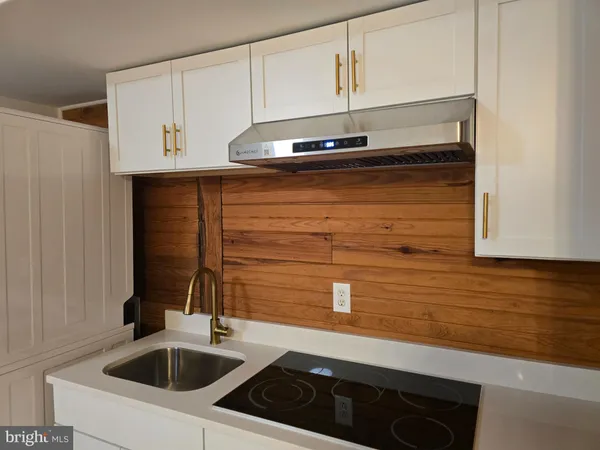 a kitchen with a sink and cabinets