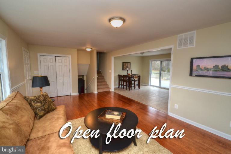 1302 Gransay Road Rosedale, MD 21237 - Photo 17 of 30 a living room with furniture and a dining table with wooden floor