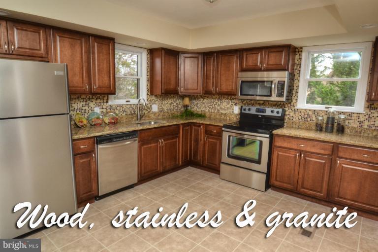 1302 Gransay Road Rosedale, MD 21237 - Photo 18 of 30 a kitchen with stainless steel appliances granite countertop a stove a sink dishwasher a refrigerator and a microwave