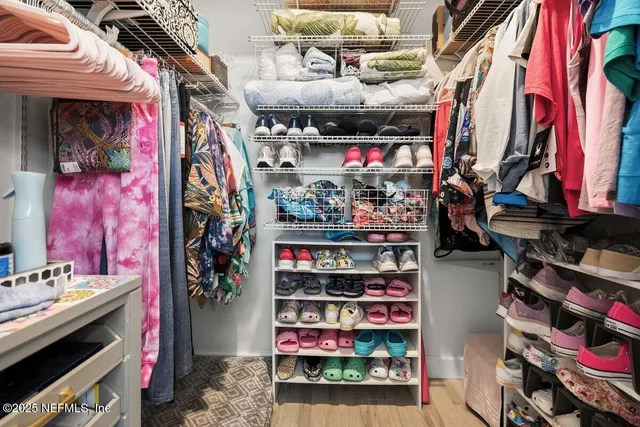 a view of a livingroom with wooden floor and a bookshelf