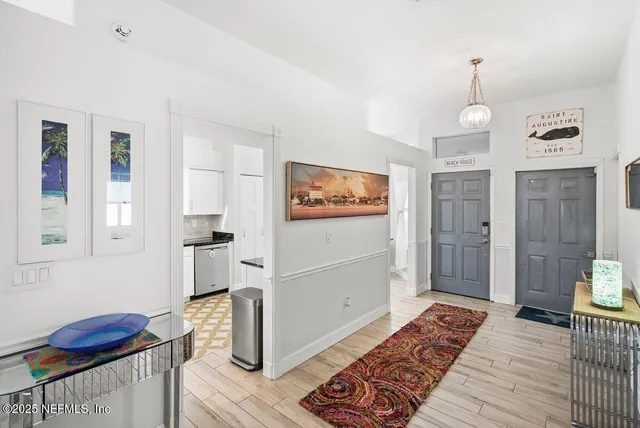 a kitchen with a refrigerator and a stove top oven