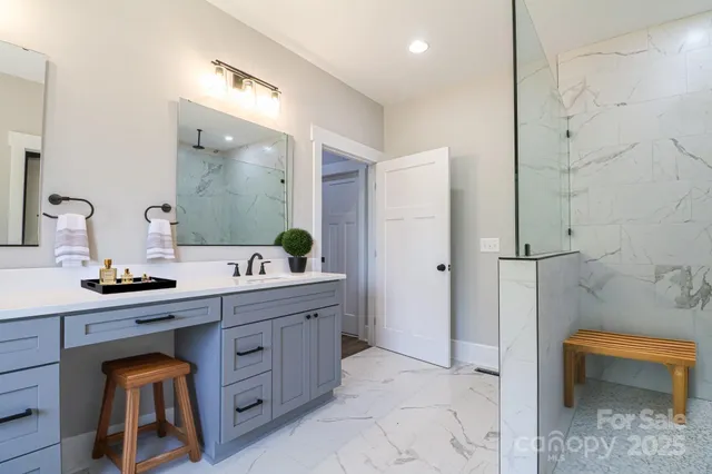 a spacious bathroom with a double vanity sink and a mirror