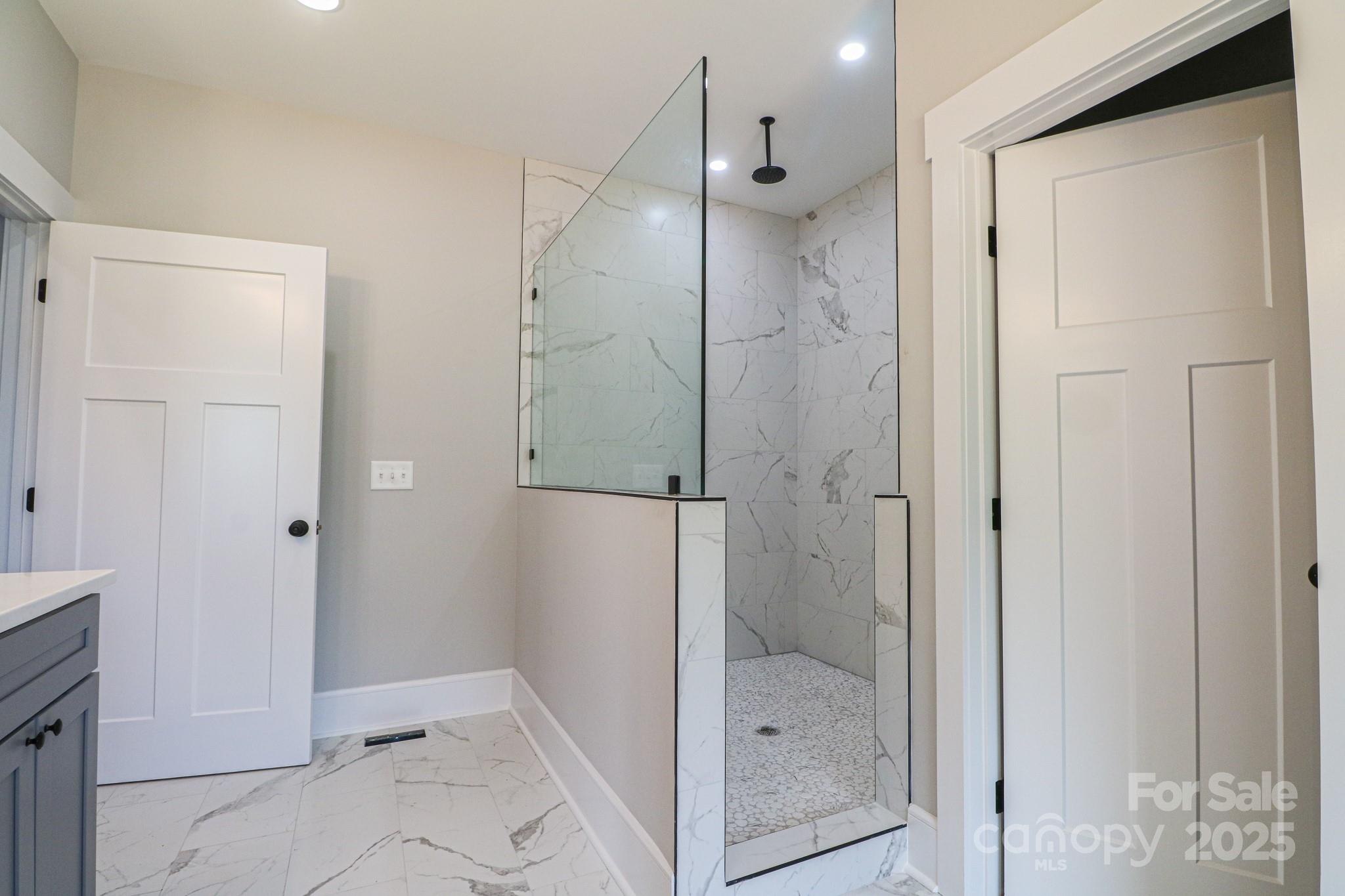 1070 Castle Ml Lane Salisbury, NC 28147 - Photo 21 of 38 a bathroom with a glass shower door