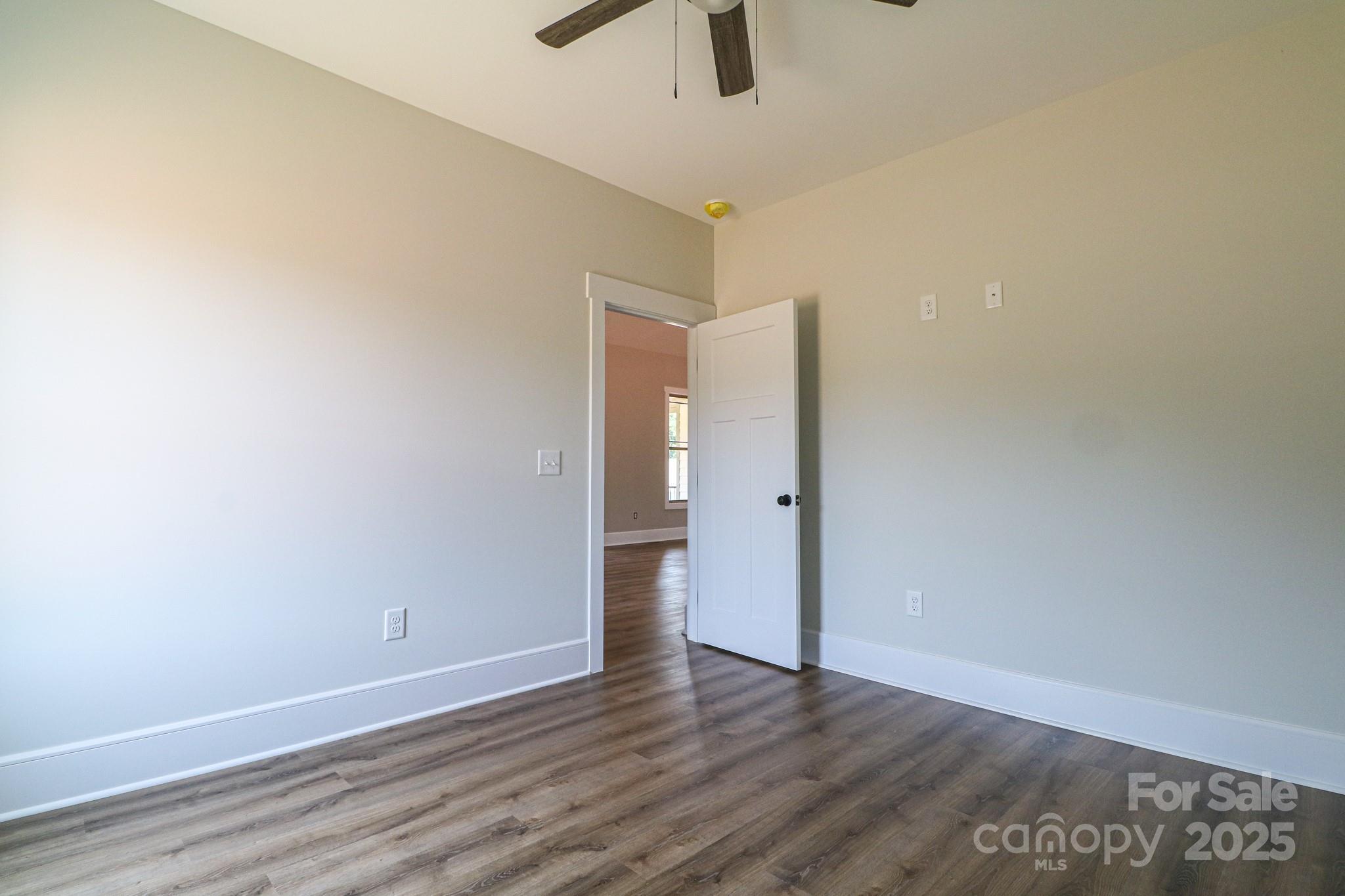 1070 Castle Ml Lane Salisbury, NC 28147 - Photo 24 of 38 a view of an empty room with window and a ceiling fan