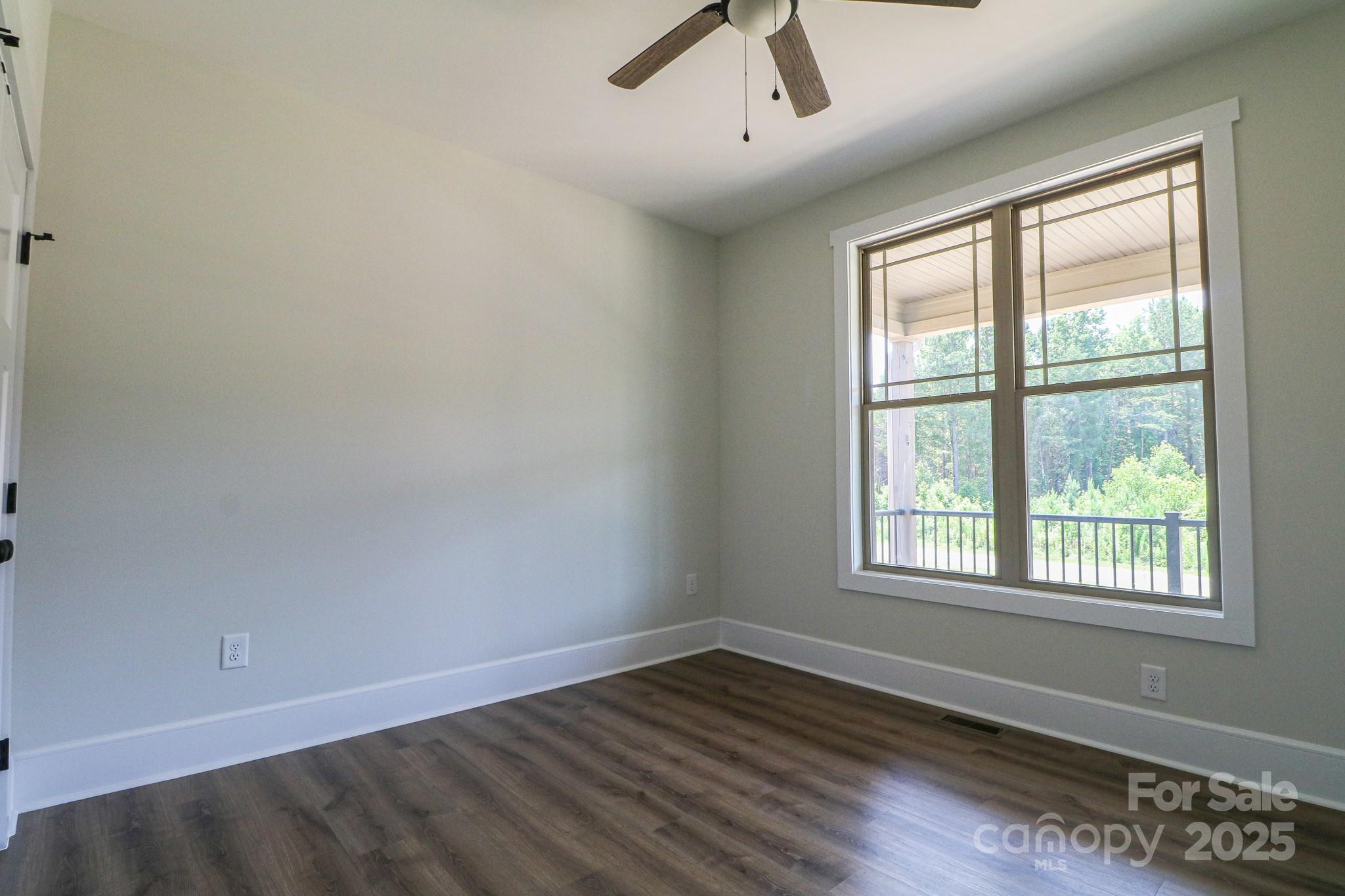 1070 Castle Ml Lane Salisbury, NC 28147 - Photo 27 of 38 an empty room with wooden floor and windows