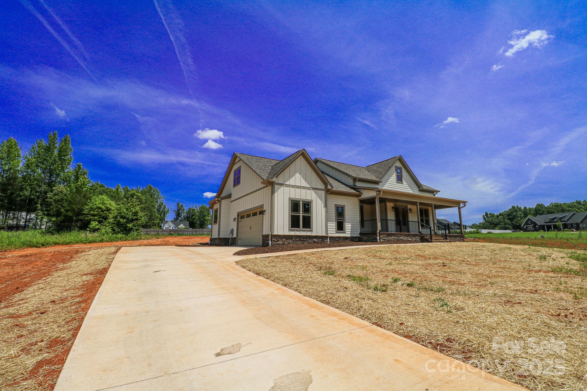 1070 Castle Ml Lane Salisbury, NC 28147 - Photo 3 of 38 a front view of a house with a yard and trees