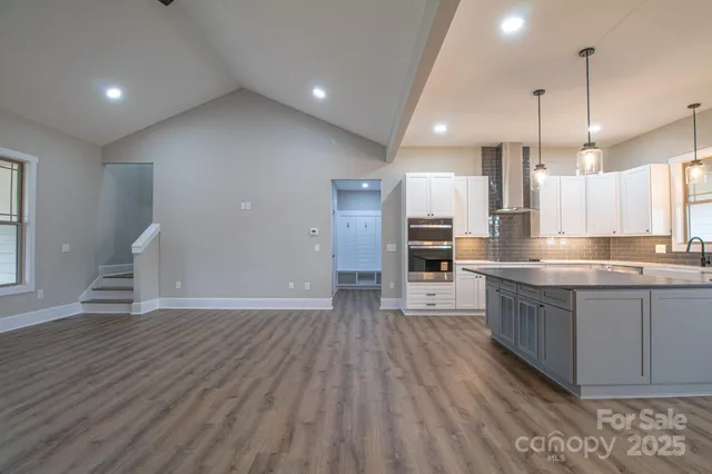 a large kitchen with lots of counter space a sink appliances and cabinets