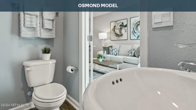 a white toilet sitting next to a bathroom sink