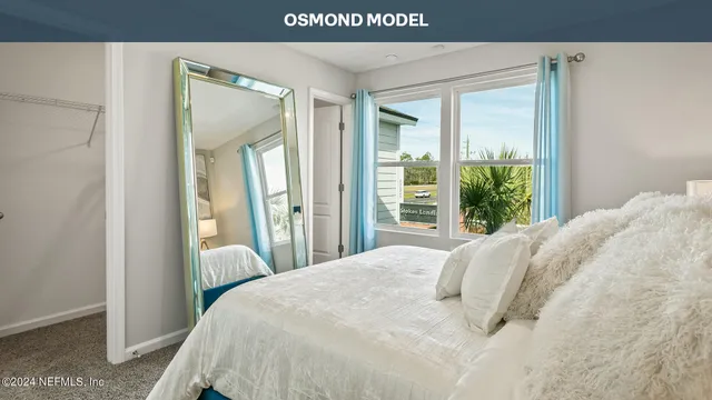 a bed sitting in a bedroom next to a window