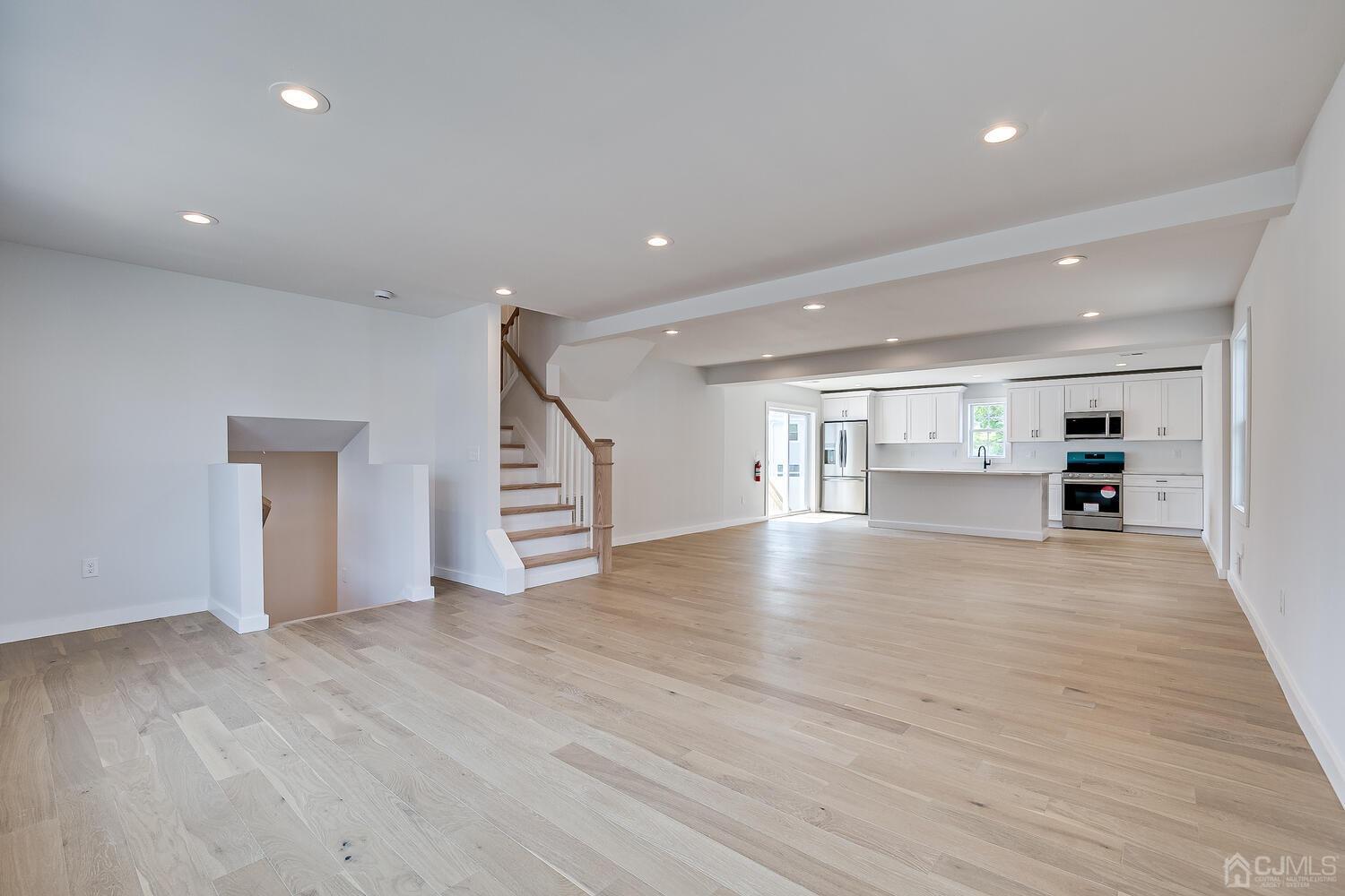 21 Brian Road Edison, NJ 08817 - Photo 11 of 47 a view of empty room with wooden floor and kitchen view