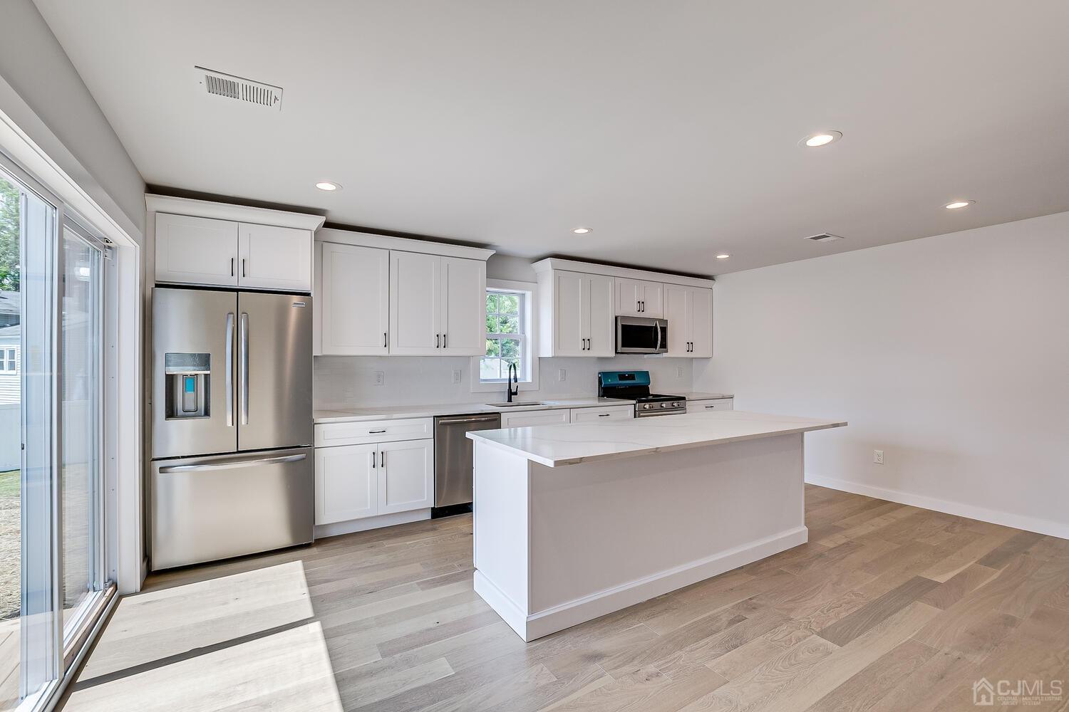 21 Brian Road Edison, NJ 08817 - Photo 20 of 47 a kitchen with white cabinets and stainless steel appliances