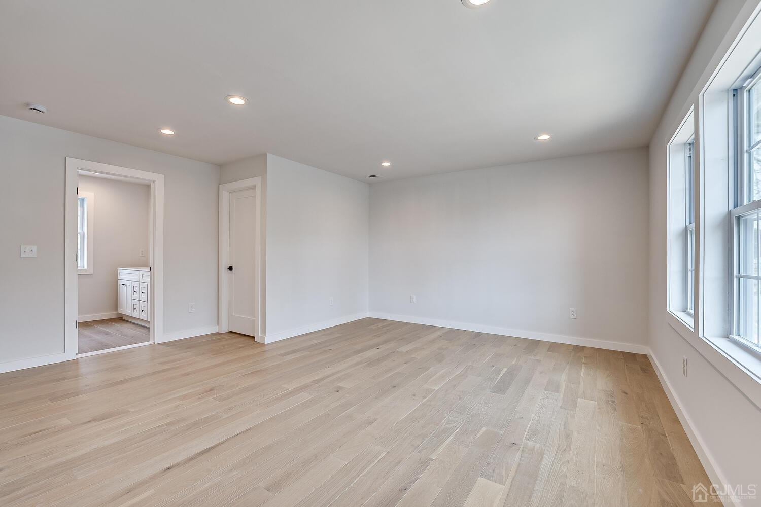 21 Brian Road Edison, NJ 08817 - Photo 24 of 47 wooden floor in an empty room with a window