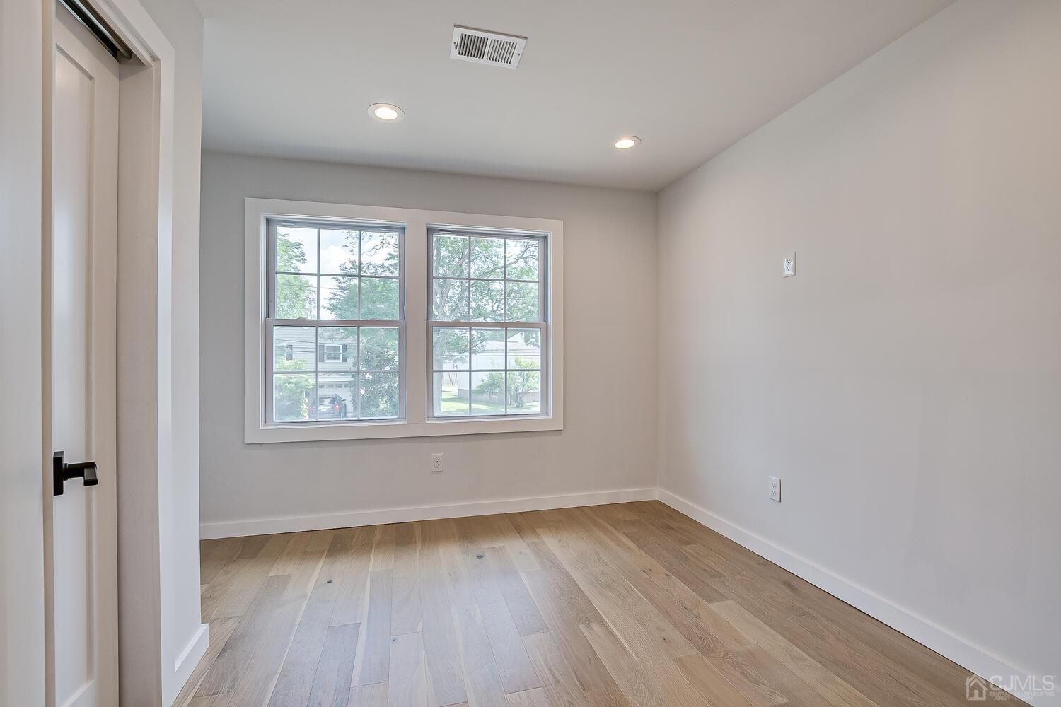 21 Brian Road Edison, NJ 08817 - Photo 38 of 47 an empty room with wooden floor and windows