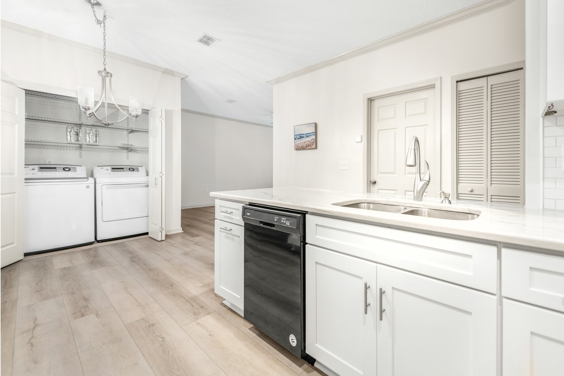 1601 Nectarine Street, Unit B2 Fernandina Beach, FL 32034 - Photo 11 of 46 a kitchen with kitchen island white cabinets and white appliances
