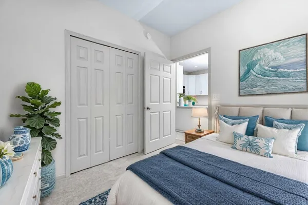 a bedroom with furniture and a potted plant
