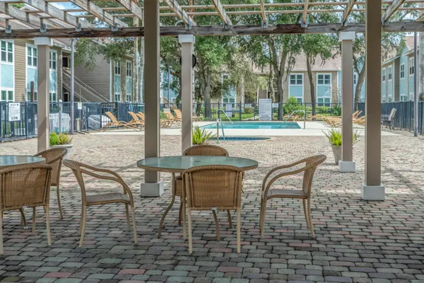 a patio with yard glass top table and chairs