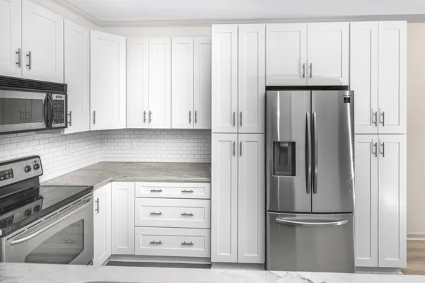 a kitchen with appliances cabinets and a refrigerator
