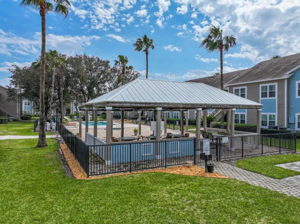 a view of a house with a backyard and a patio