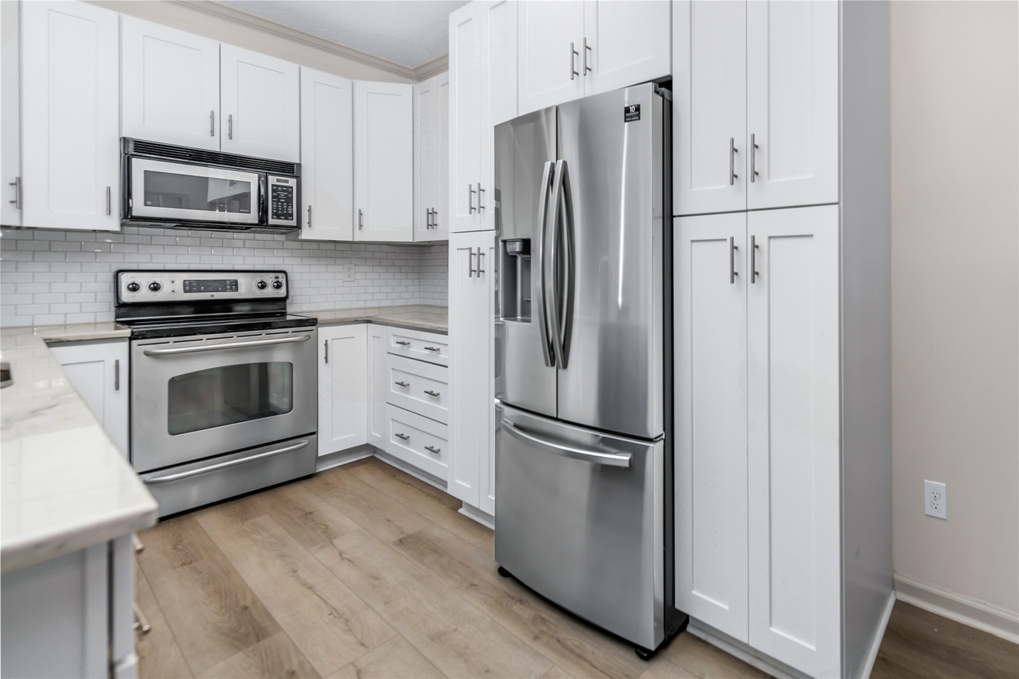 1601 Nectarine Street, Unit B2 Fernandina Beach, FL 32034 - Photo 10 of 46 a kitchen with stainless steel appliances a refrigerator stove and microwave