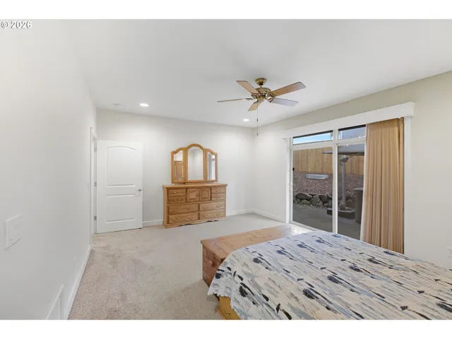 a living room with a bed furniture and a large window