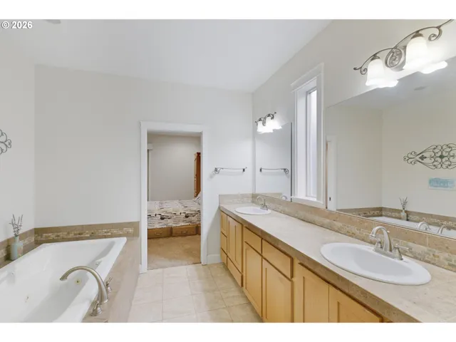 a bathroom with a granite countertop sink mirror and double