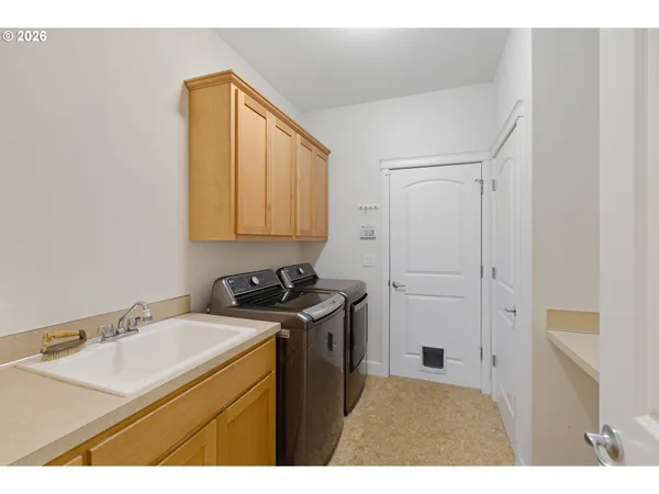 a kitchen with a sink cabinets and a stove