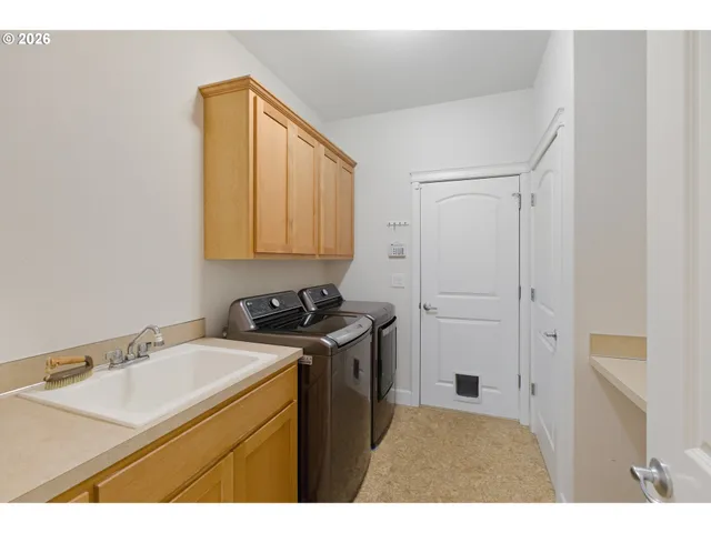 a kitchen with a sink cabinets and a stove