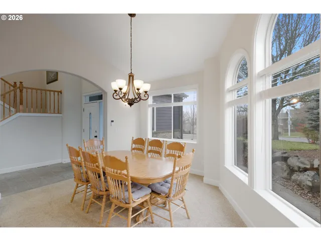 a view of a dining room with furniture and a chandelier