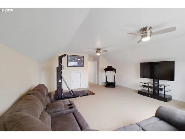 a backyard of a house with wooden floor and outdoor seating