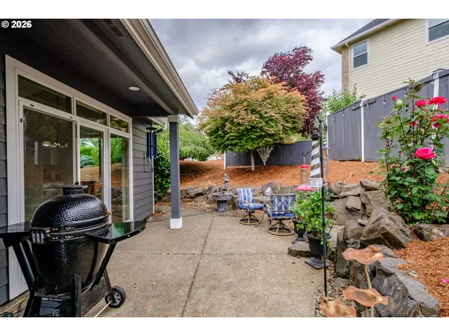 a patio with a table and chairs under an umbrella