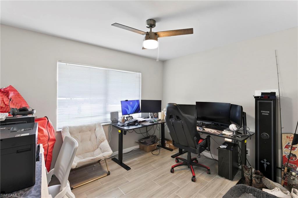 8264-8268 Matanzas Road Fort Myers, FL 33967 - Photo 13 of 33 a view of a workspace with furniture and a ceiling fan