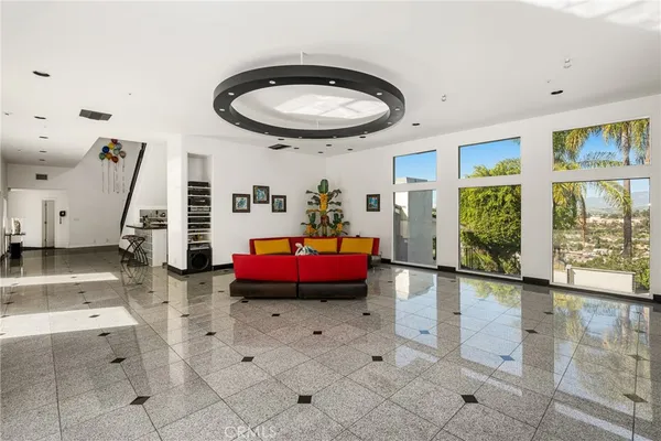 a living room with furniture and large windows