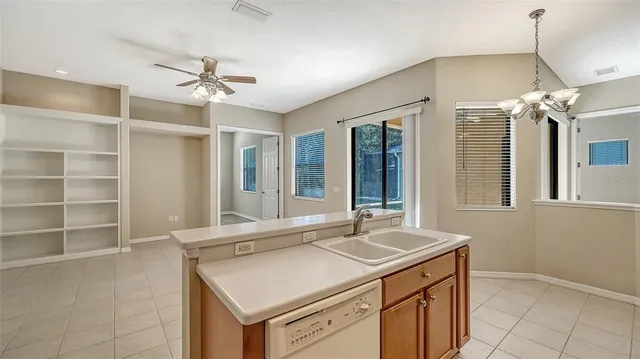a backyard of a house with plants and large tree