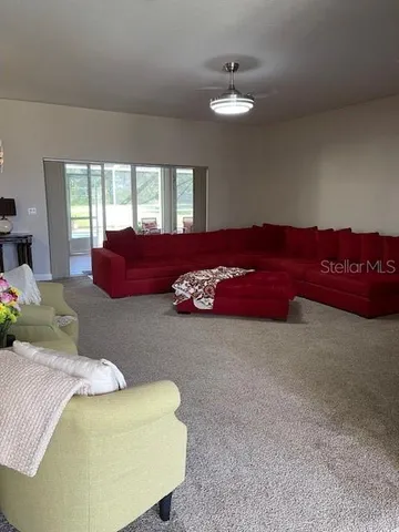 a living room with furniture and a mirror